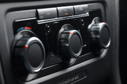 Car climate control panel with temperature and airflow dials at MJZ Garage.