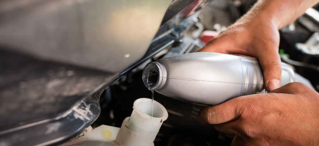 Automotive oil change being performed by technician at MJZ Garage.