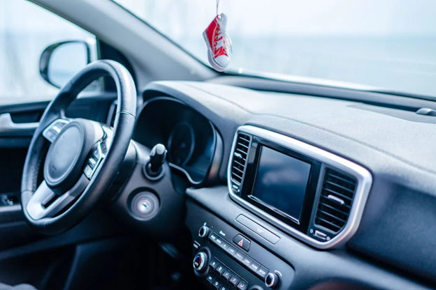 Interior view of a vehicle showcasing the dashboard, steering wheel, and infotainment screen for car.