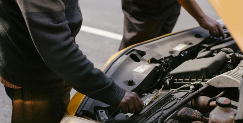 Mechanic inspecting a car engine at MJZ Garage, expert auto repair services in a trusted local auto.