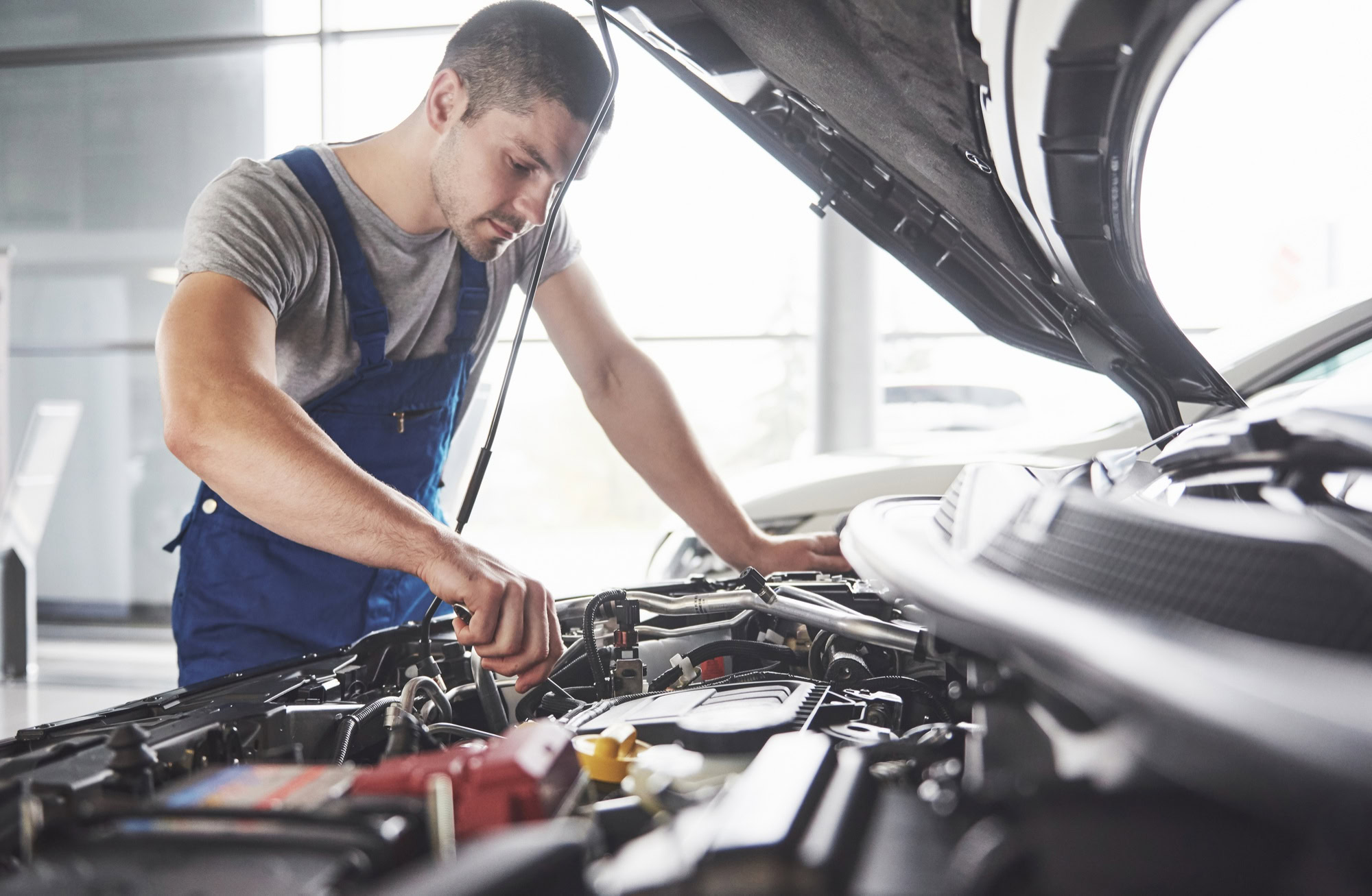 Mechanic performing engine repairs