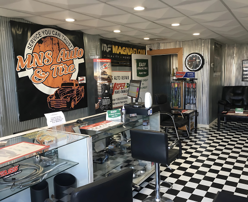 Auto repair shop reception area with service counters and seating.