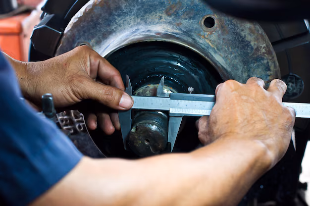 Mechanic measuring dimensions of tire