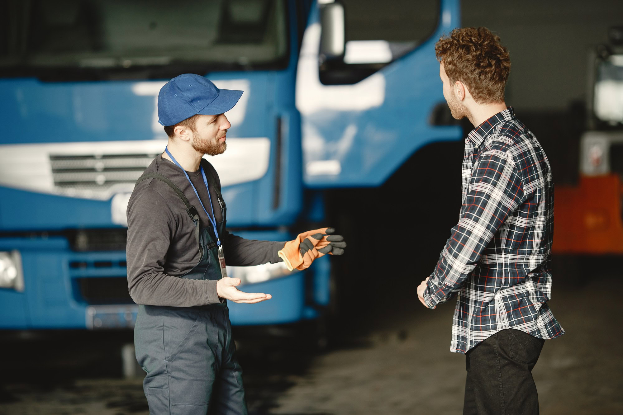 Mechanics discussing vehicle repairs