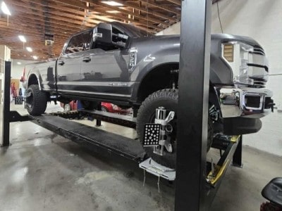Truck on lift at Mobile Man Auto Repair for maintenance and repairs.