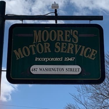 Exterior sign of Moore's Motor Service on Washington Street.