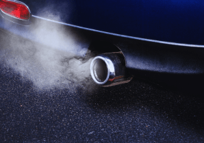 Car exhaust pipe emitting smoke on the road.