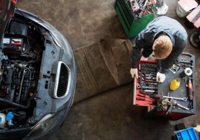 Auto repair technician working on car engine in Sioux Falls, SD.