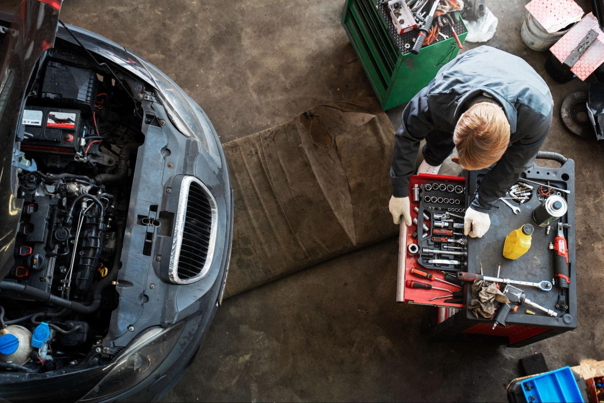 Auto repair technician working on car engine in Sioux Falls, SD.