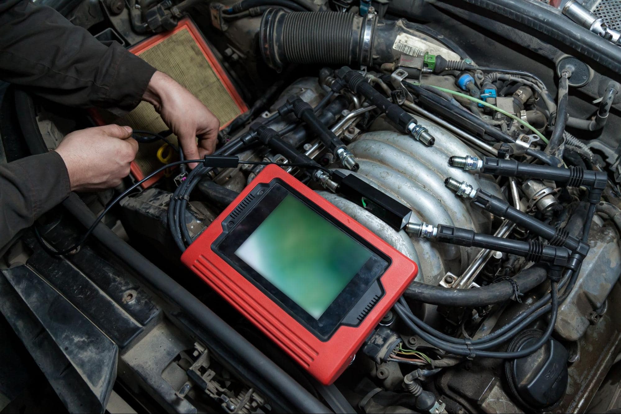 Car engine diagnostic scanner testing vehicle engine health and performance.