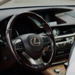 Luxury Lexus vehicle interior with advanced dashboard and steering wheel features.