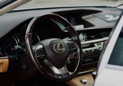 Luxury Lexus vehicle interior with advanced dashboard and steering wheel features.