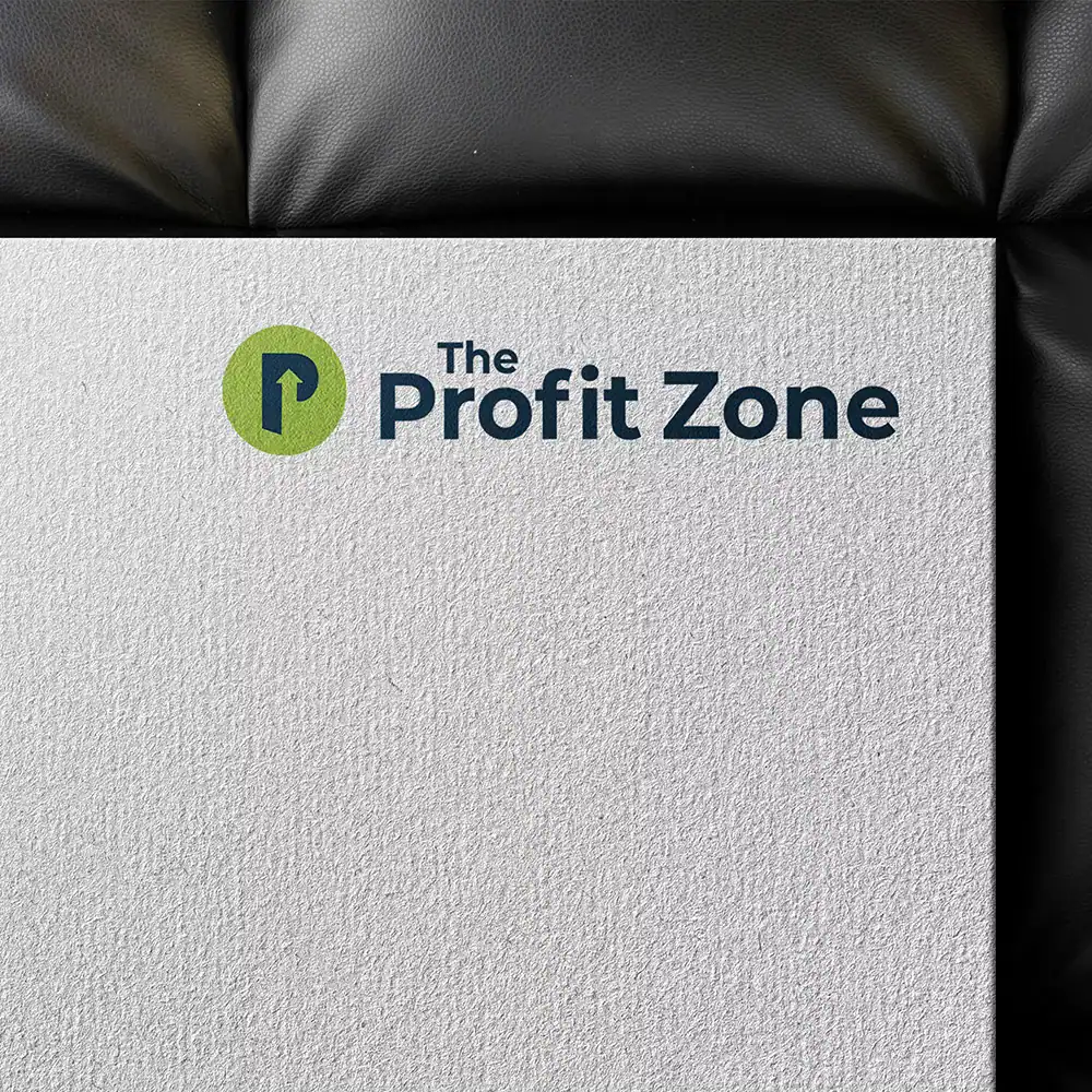 Profit Zone logo on textured paper with black leather background, representing financial growth.