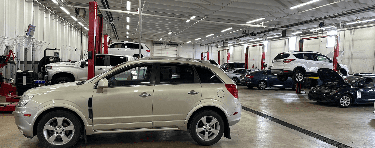 Auto repair shop with cars being serviced inside the facility.