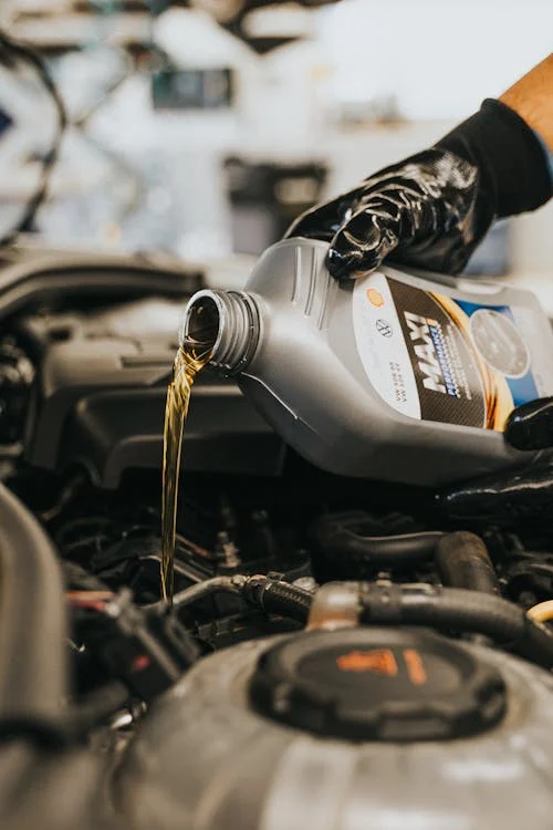 Engine oil change for vehicle maintenance and seasonal auto care.