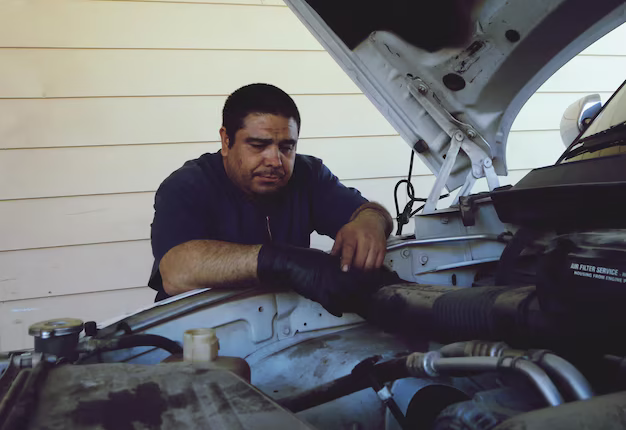 mechanic repairing car engine