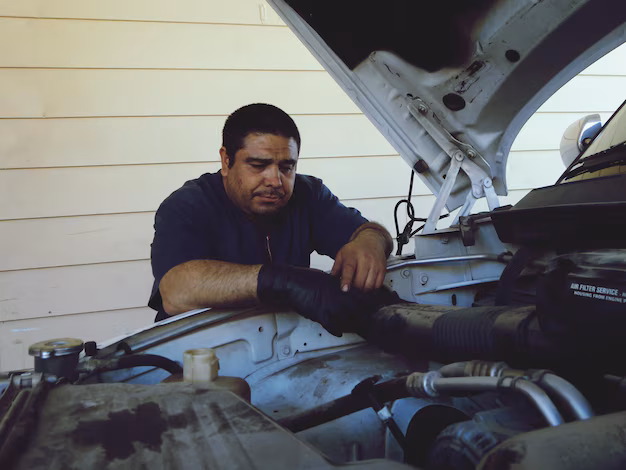 mechanic repairing car engine