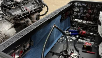 Close-up of a car engine being serviced in a professional garage.
