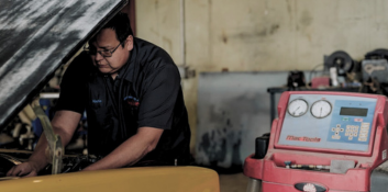 Auto repair technician working on a vehicle engine.