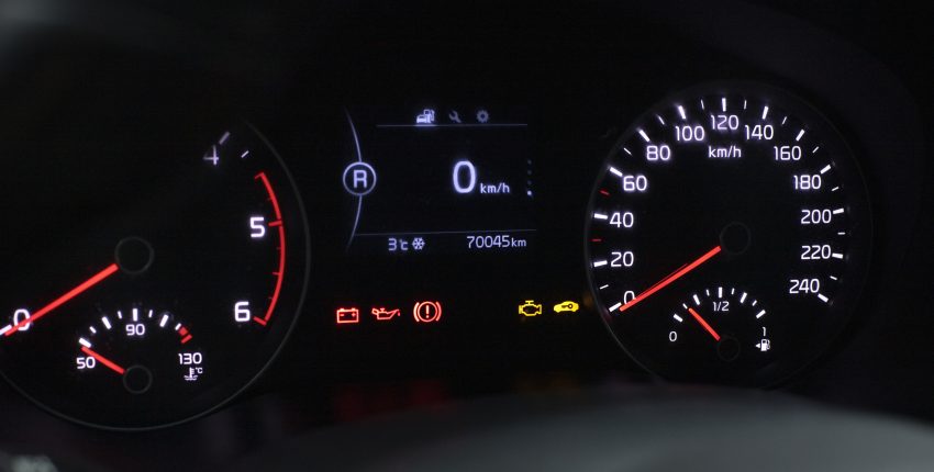 Vehicle dashboard showing warning lights during cold weather.
