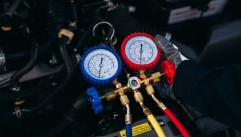 Car AC manifold gauge set for automotive air conditioning repair.