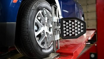 Wheel alignment machine performing service on vehicle tire at Nathan's Garage Ltd.