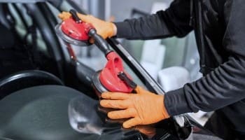 Technician using power tools for car maintenance at Nathan's Garage Ltd.