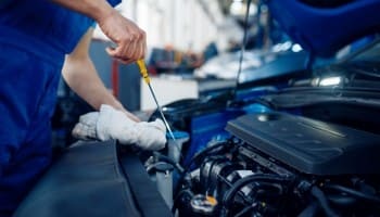 Technician inspecting car engine at Nathan's Garage Ltd.
