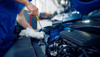 Technician inspecting car engine at Nathan's Garage Ltd.