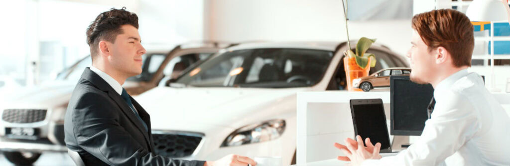 Customer consulting with technician at Newcastle Auto Repairs dealership.