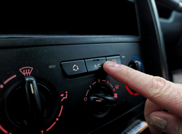 Car A/C panel showing temperature and airflow controls.