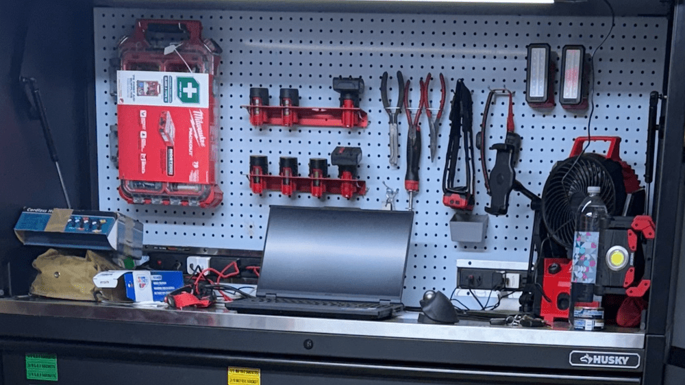 Mobile auto repair tools and equipment on a workbench in a garage.