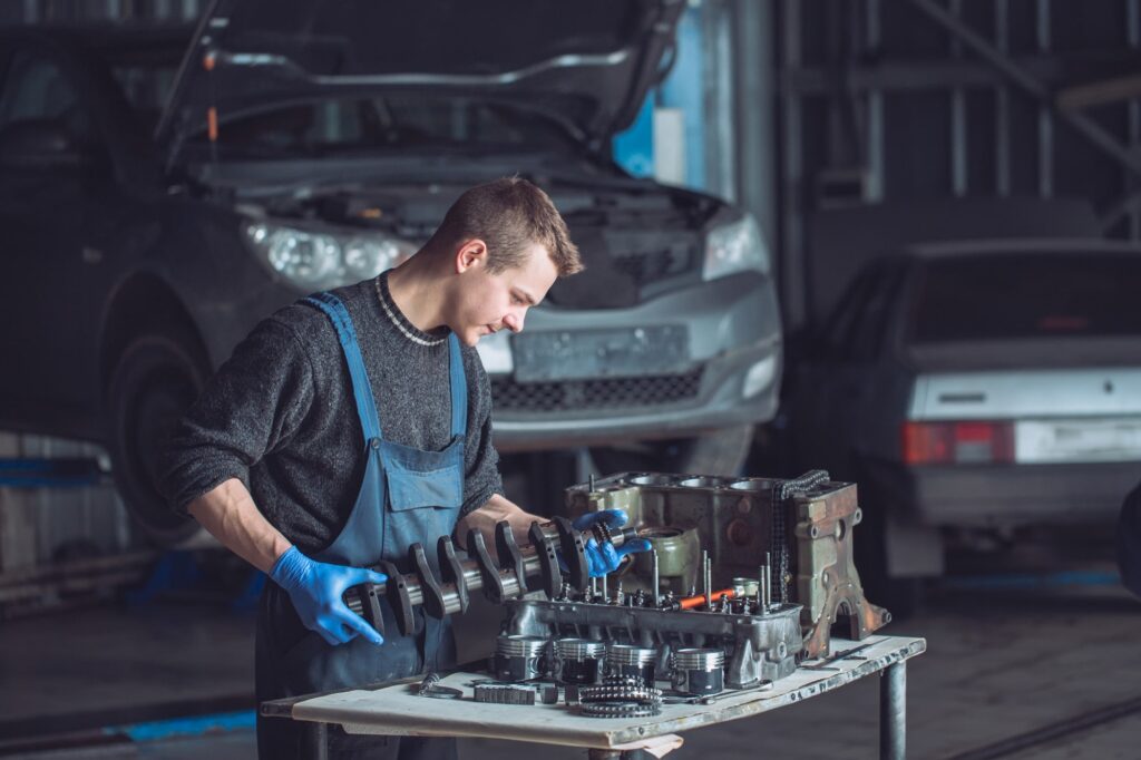 Skilled mechanic working on engine repair at Oklahoma auto repair shop.