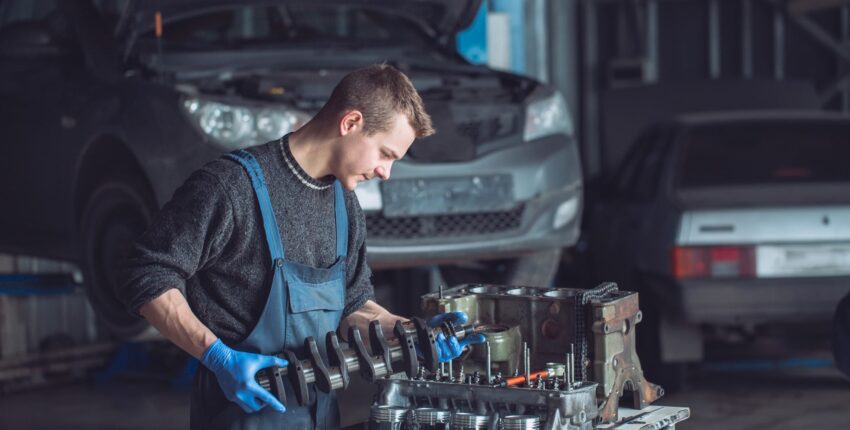 Skilled mechanic working on engine repair at Oklahoma auto repair shop.