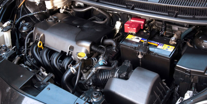 Engine bay of a modern vehicle showing various mechanical and electrical parts.
