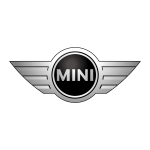 Close-up of Mini Cooper emblem on car grille.