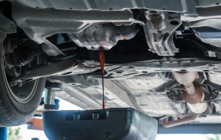 Transmission fluid drain during vehicle maintenance at Transmission Exchange of Chickasha.