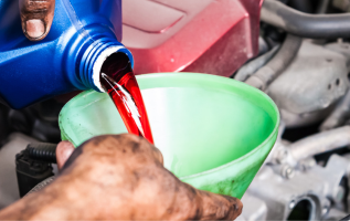 Transmission fluid being refilled at Transmission Exchange of Chickasha for vehicle maintenance.