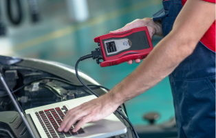 Technician performing vehicle diagnostics with scanner at Transmission Exchange of Chickasha.