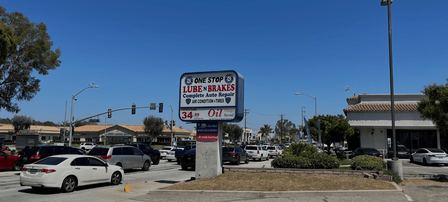 Automotive service sign for oil change and brake repair at One Stop Lube.