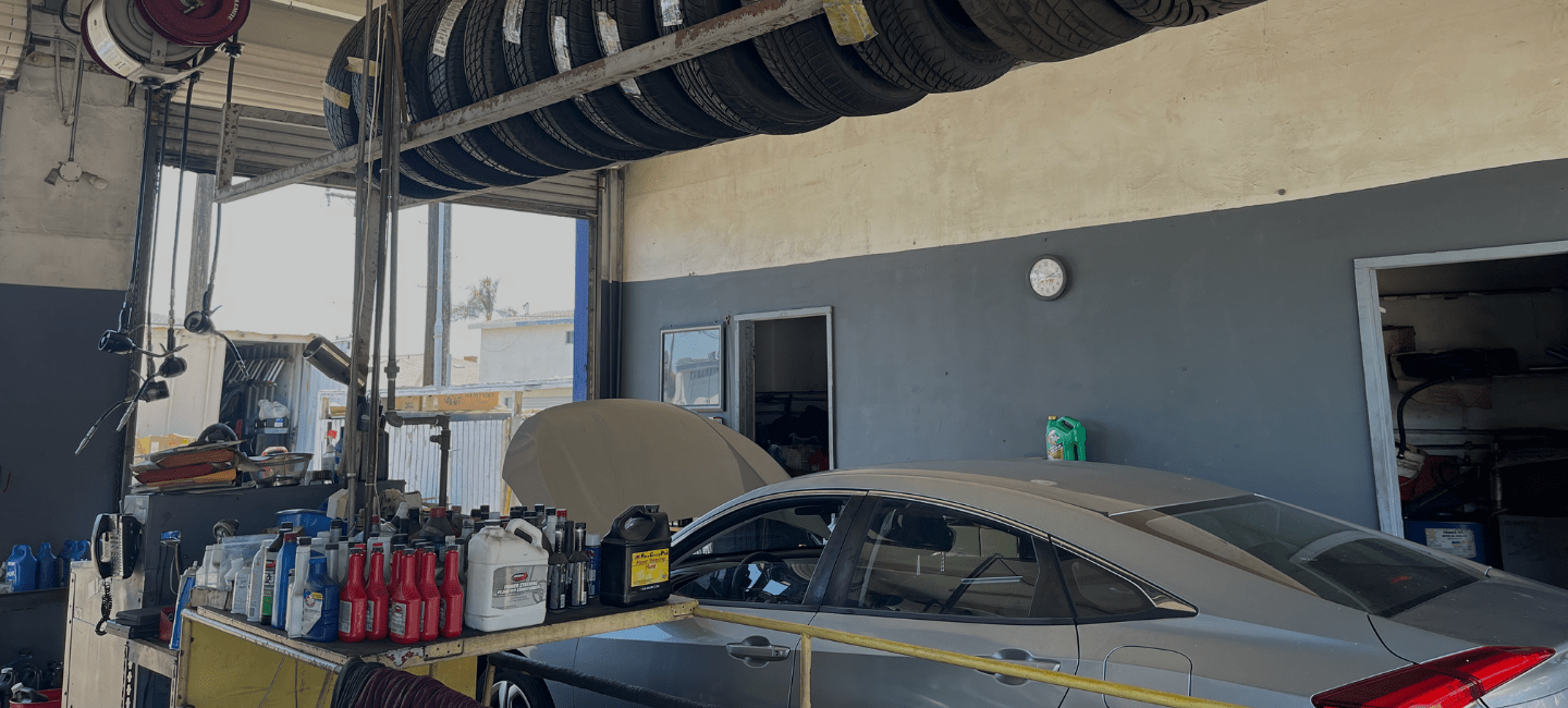 Car being serviced at One Stop Lube auto repair shop.