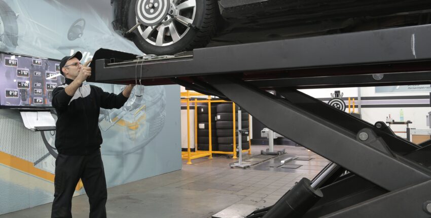 Auto repair shop car lift for oil change and maintenance.