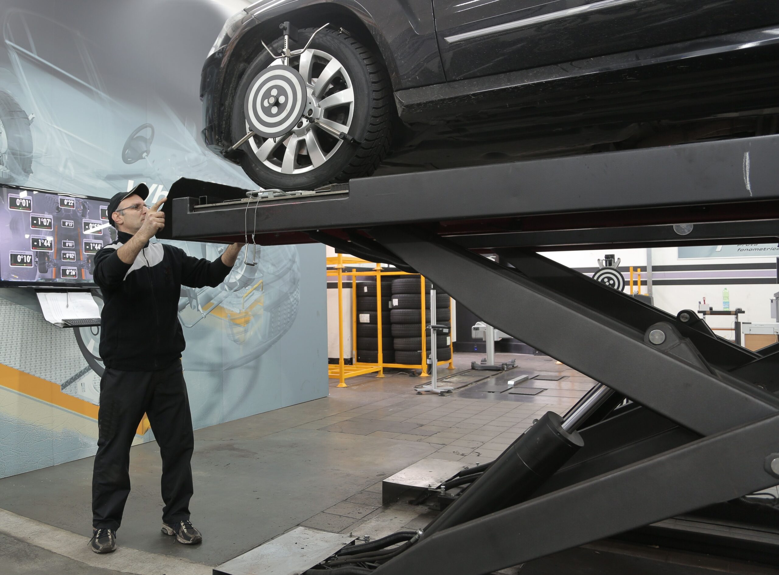 Auto repair shop car lift for oil change and maintenance.