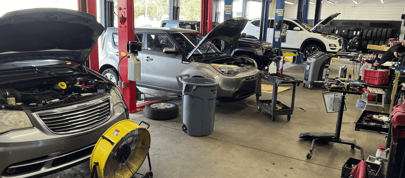 Auto repair shop with cars being serviced and maintained in Orlando. Expert vehicle diagnostics and.