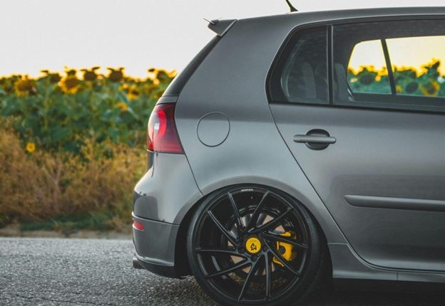 Custom black alloy wheels on a modern hatchback vehicle.