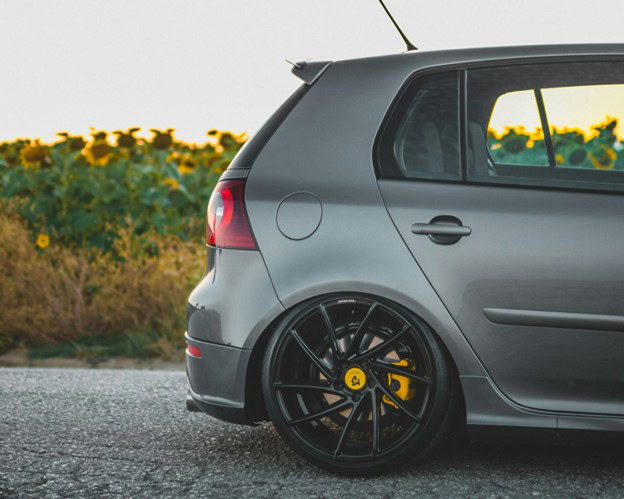 Custom black alloy wheels on a modern hatchback vehicle.