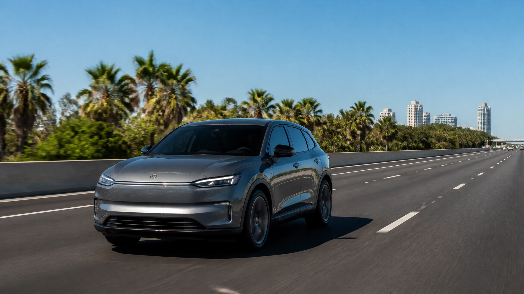 Electric vehicle driving on highway near Orlando with palm trees.