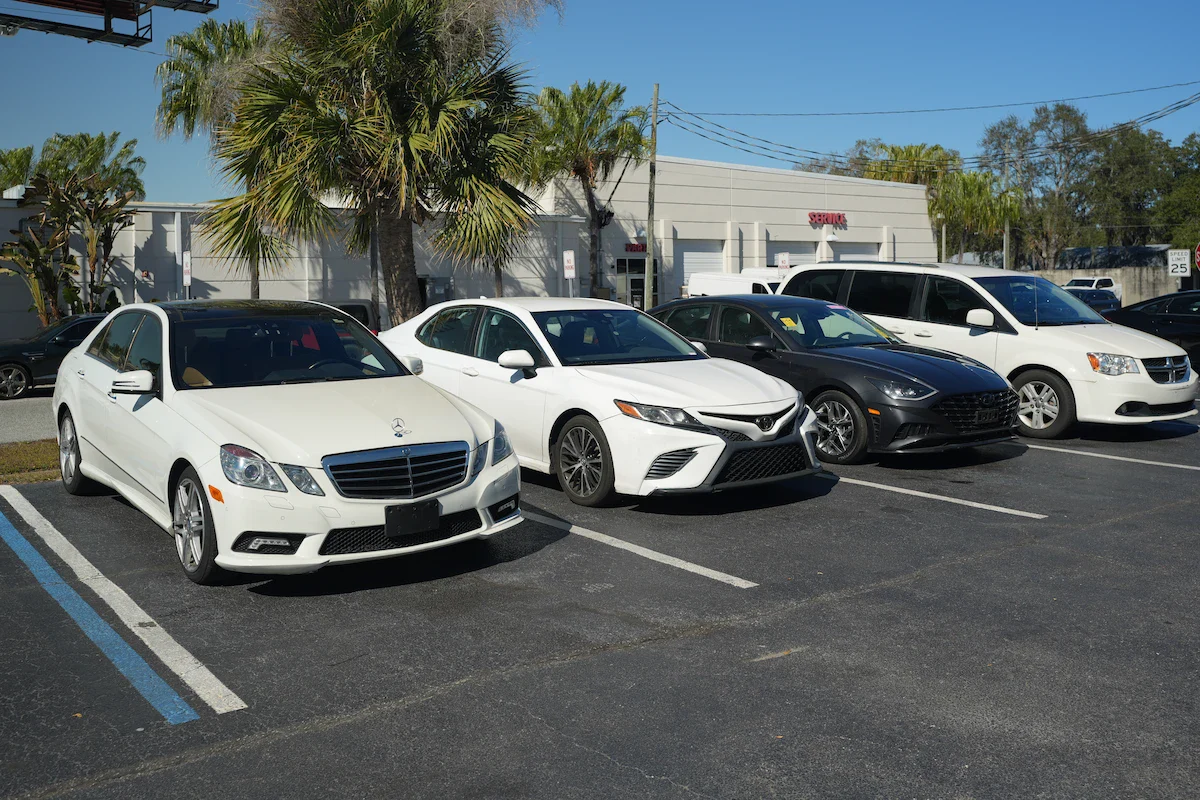 Line of luxury and family cars parked at Orlando Auto Repair.