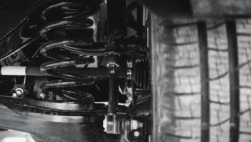 Close-up of diesel engine parts and suspension system at Panhandle Diesel Performance LLC.