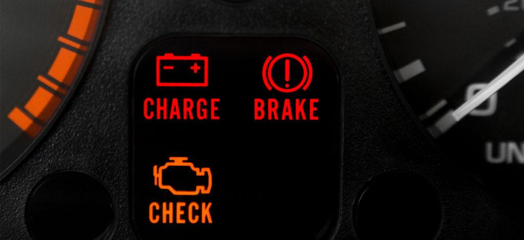 Vehicle dashboard with engine check, charge, and brake warning lights at Panhandle Diesel Performanc.